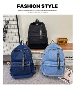 Close-up of denim backpacks in black and blue with trendy fashionbag strap pendants