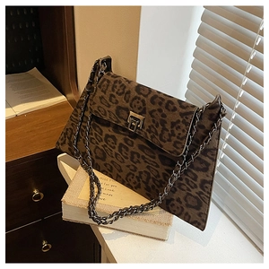 Detail of leopard print crossbody bag with vintage metal turn-lock and chain strap