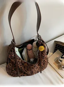 Detailed view showing the spacious interior of a leopard print tote bag with daily items