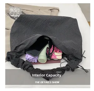 Macro view of checkered tote bag interior showing capacity for bottles and daily essentials