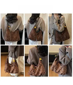 Leopard print tote bag with brown straps and yellow pom-pom shown on model shoulder