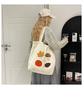 Détail d'un sac cabas en velours côtelé blanc avec broderie d'automne et feuilles d'érable