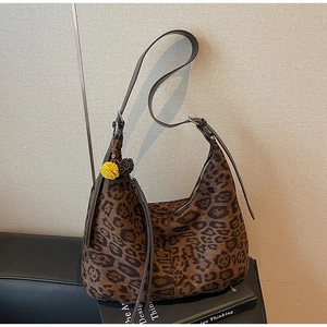 Leopard print crossbody tote bag detail with brown leather strap and tassel zip