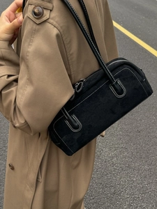 Retro black suede Boston handbag with contrast stitching worn over the shoulder