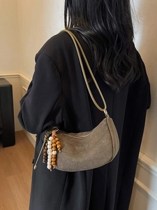 Brown suede half-moon shoulder bag with retro wooden beads and minimalist leather strap