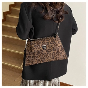 Close-up of leopard print crossbody bag with silver buckle and chain leather strap