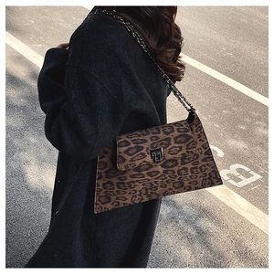 Detail of leopard print crossbody bag with silver square lock and chain strap