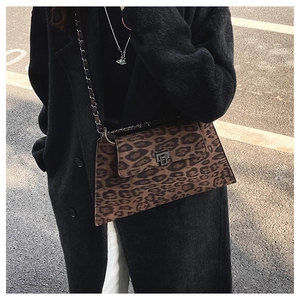 Detail of vintage leopard print crossbody bag with silver metal turn-lock and chain strap