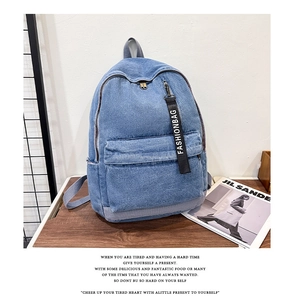 Detailed view of durable blue denim backpack fabric with a black Fashionbag strap accent