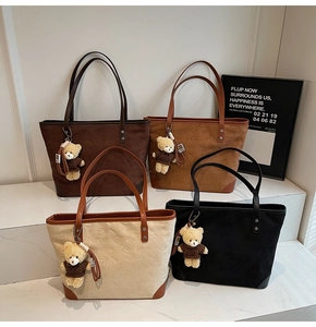 Detail view of four tote bags in coffee, camel, cream and black with bear embossing