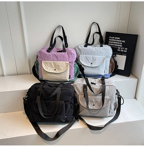 Detailed view of canvas crossbody bags in lavender, blue, black and grey options