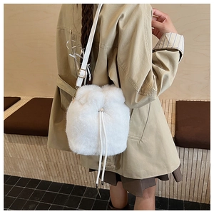 Detail einer weißen Plüsch-Beuteltasche mit Tunnelzug und verstellbarem Lederriemen