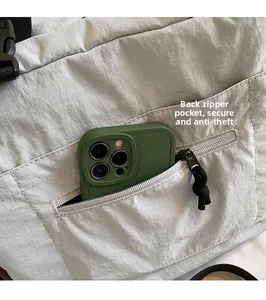 Detail of grey plaid crossbody bag showing secure anti-theft back zipper pocket