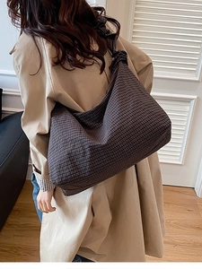 Minimalist large canvas shoulder bag with brown plaid pattern shown on model back