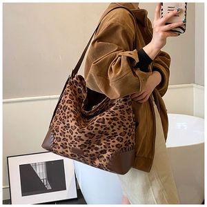 Large vintage leopard print tote bag with brown leather trim and wide shoulder strap