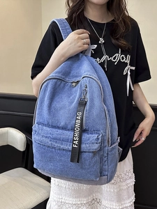 Large denim backpack for travel and school featuring a stylish fashion ribbon charm