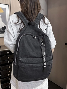 Vintage black washed denim backpack with fashion strap detail for travel and school