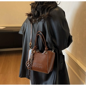 Detailed close-up of dark brown vintage faux leather texture and embossed relief letters