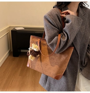 Brown suede tote bag with 3D bear embossing and a plush bear charm on the strap