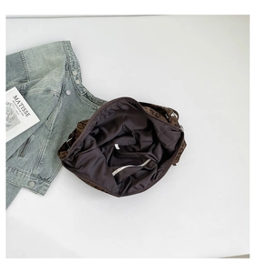 Interior detail of leopard print tote bag with brown lining and multi-pocket storage