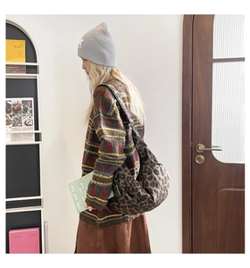 Leopard print crossbody bag shown from a side view on a model with vintage knitwear