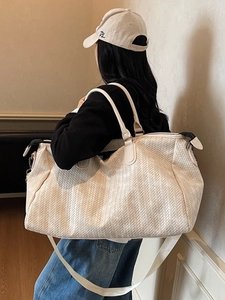 Large cream woven texture travel bag with dual handles and adjustable shoulder strap