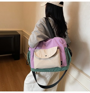 Detail view of a large capacity patchwork canvas messenger bag with adjustable strap