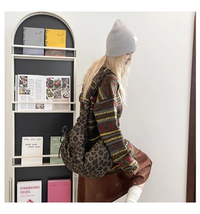 Detail of leopard print drawstring crossbody bag styled with trendy autumn winter knitwear