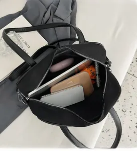 Internal view of the large black tote bag showing organized storage and spacious compartments