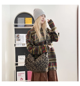 Close-up of vintage leopard print crossbody dumpling bag with autumn knitwear styling
