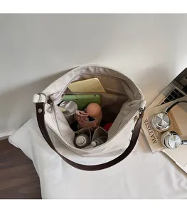 Interior view showing the large storage capacity of the embroidered canvas tote bag