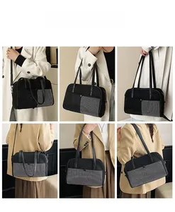 Detail showing black shoulder bag with silver stud grid pattern and leather strap
