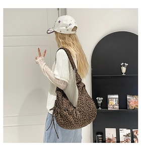 Leopard print hobo bag worn by model showing its large capacity and stylish drape