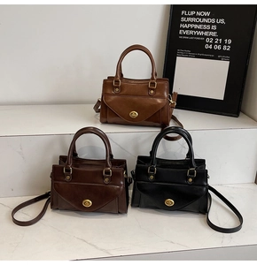 Detailed view of vintage square handbags in brown and black with metal twist locks