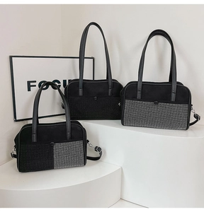 Detailed view of three black matte handbags with varied rhinestone finishes and straps