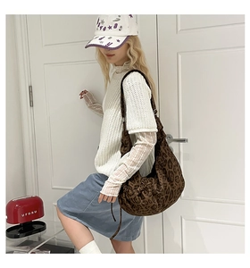 Detail of a large leopard print canvas tote bag styled with casual retro street outfits
