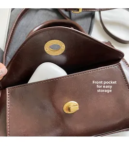Detail of vintage oil wax leather bag featuring a front pocket for functional storage