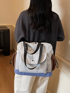 Minimalist color-block tote bag with adjustable strap and multiple storage pockets