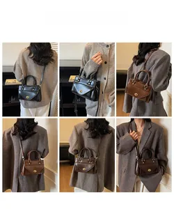 Detailed views of vintage trapezoid handbag shown in handheld and crossbody styles