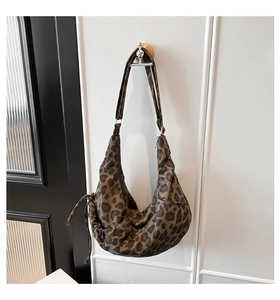 Close-up of leopard print hobo bag showing large capacity and adjustable shoulder strap