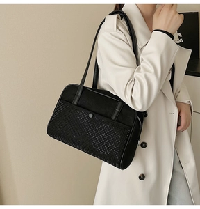 Detail showing high-quality black suede texture with dense rhinestones on a stylish shoulder bag