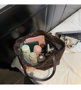 Interior view showing the large capacity and striped lining of this leopard print tote bag