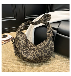 Detail view of leopard print hobo bag showing wide strap and durable canvas texture