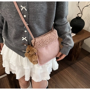 Pink suede crossbody bag with fleece trim and cute brown plush bear charm detail