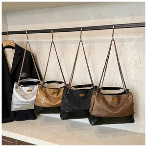 Quilted tote bags in black, bronze, silver and brown with classic chain straps and metal locks