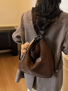 Vintage brown large capacity backpack in matte leather finish shown on model