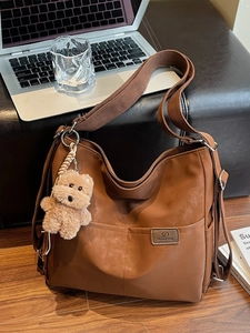 Brown vintage large capacity tote bag with wide strap and teddy bear pendant