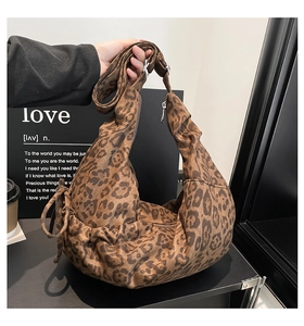 Detail of leopard print hobo bag showing the soft fabric texture and side drawstring pleats