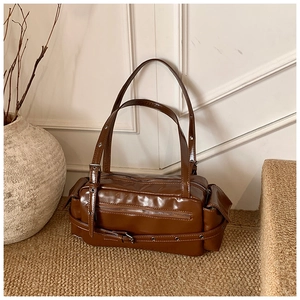 Detailed close-up of a vintage brown PU leather shoulder bag with multi-zipper compartments