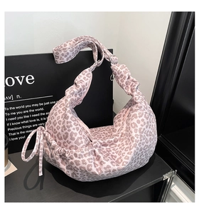 Detail of leopard print hobo bag showing pleated drawstring texture and spacious design